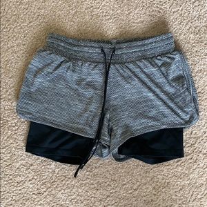 Running shorts with attached compression shorts